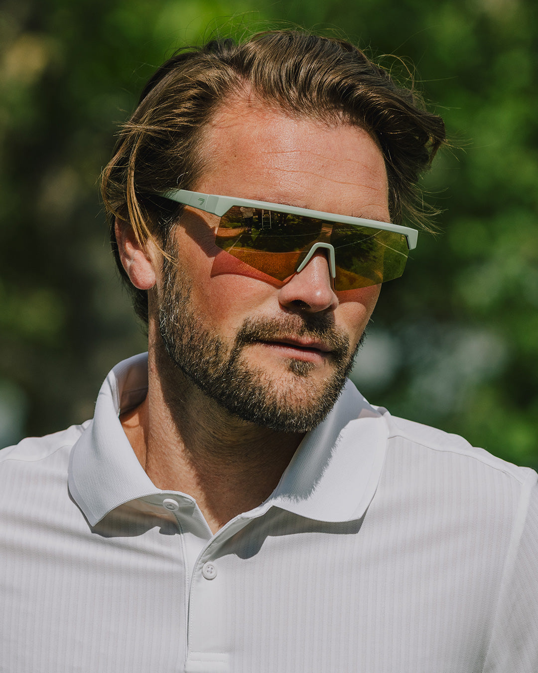 The ACE Hub Johnny Loco sport glasses with mirrored lenses, worn outdoors in sunlight.