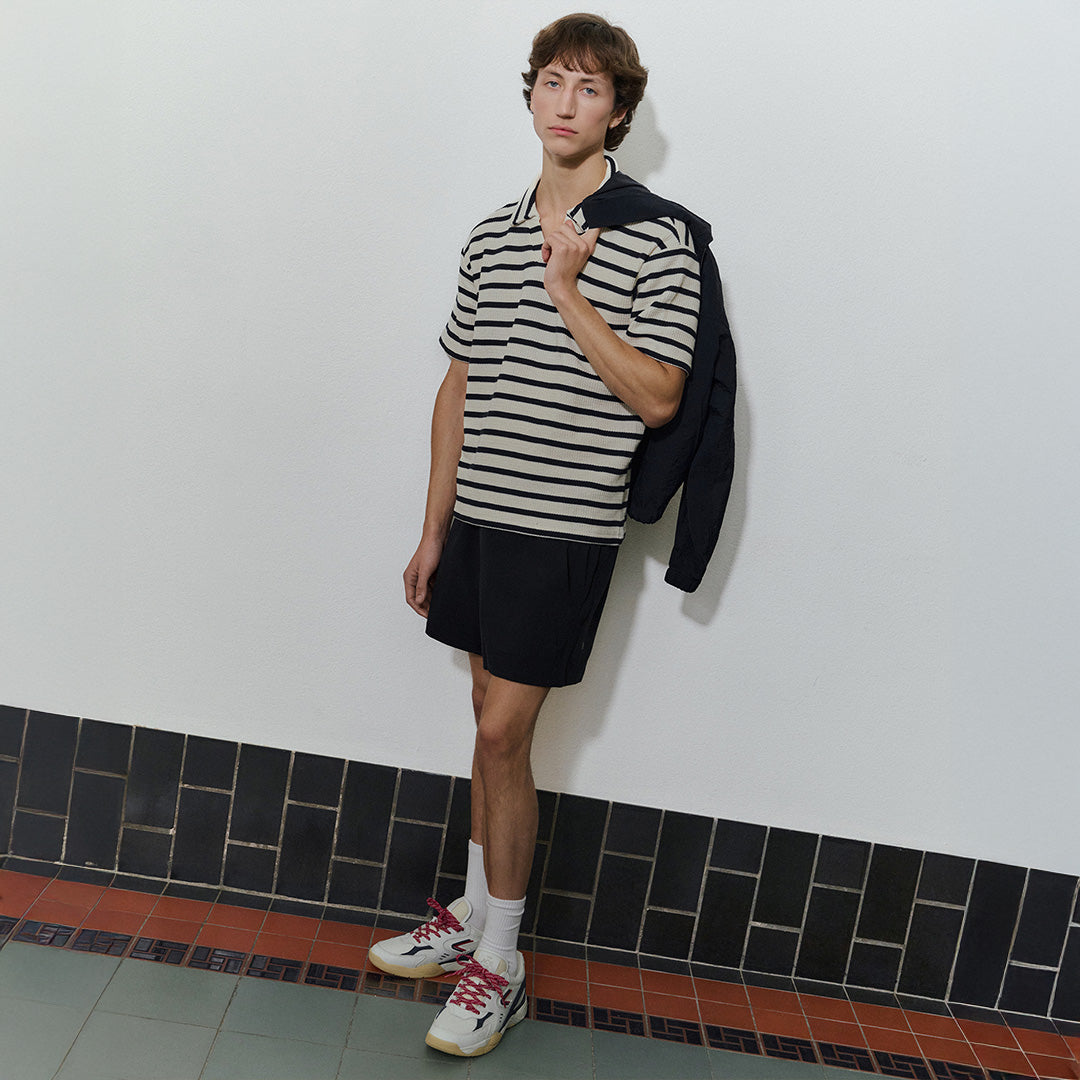 he ACE Hub ACE25 sneaker in white and navy with , photographed indoors at an art museum.