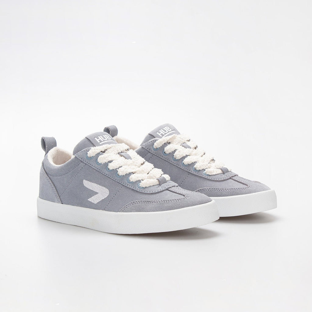 Pair of light blue HUB sneakers with white fluffy laces on a white background

